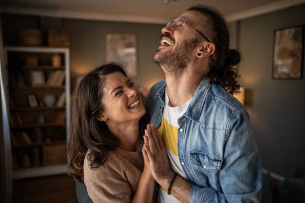 Couple laughing together outdoors