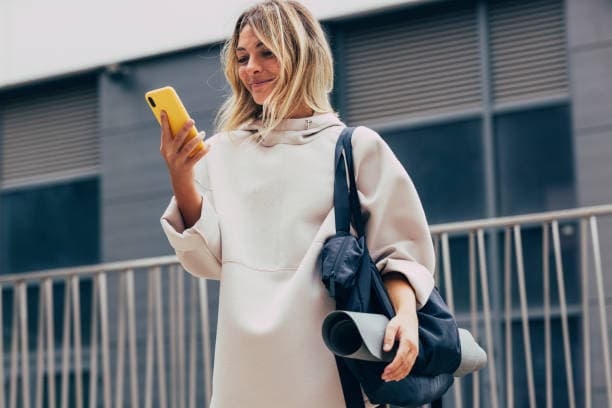 Woman outdoors checking her phone